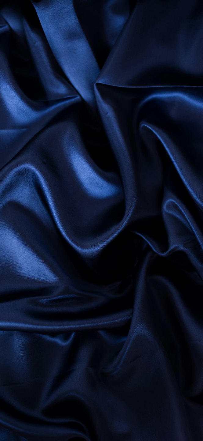 Dark blue satin fabric with soft flowing folds.